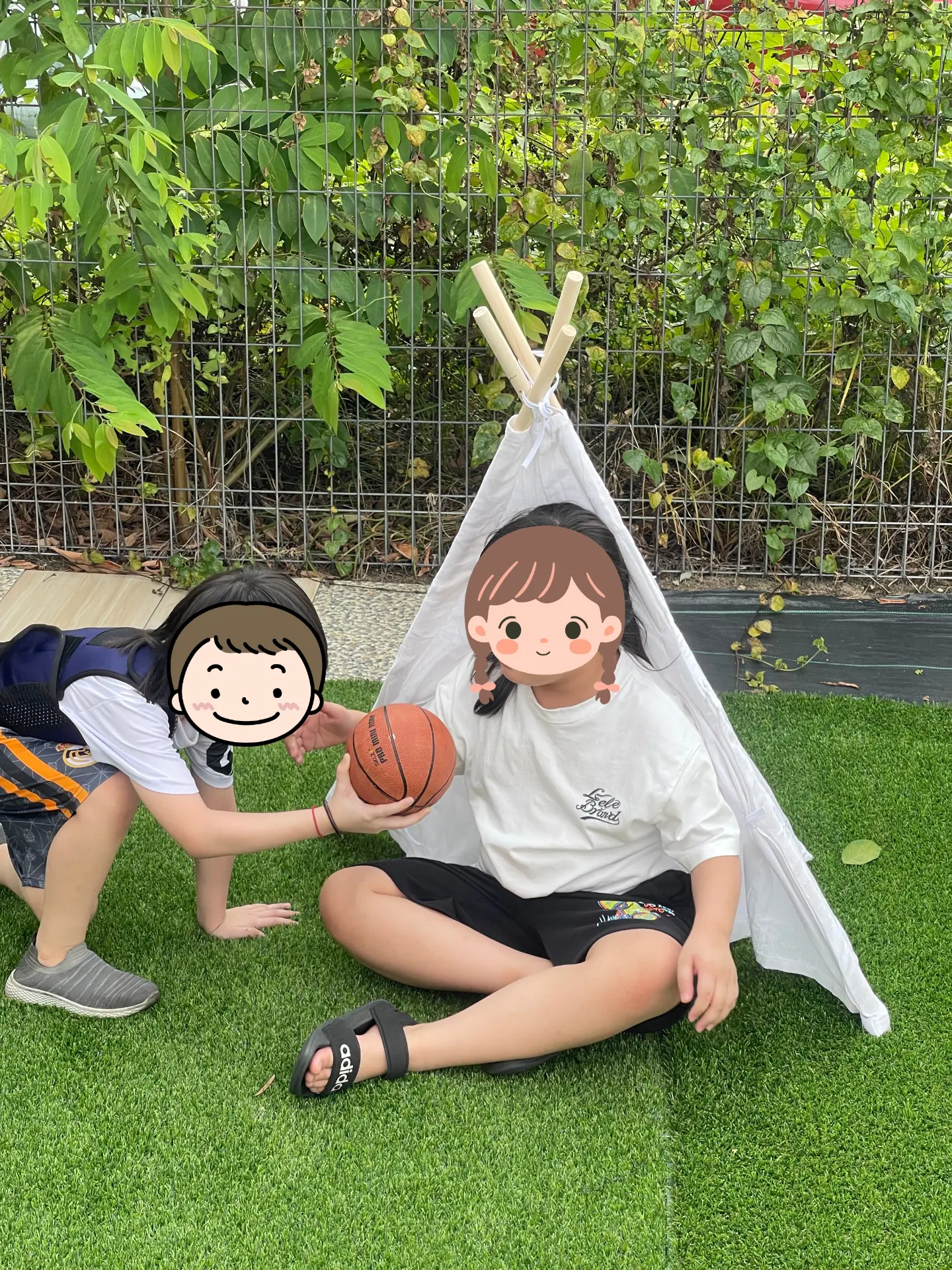 Children sitting outdoors with a therapist for a group activity on the lawn.